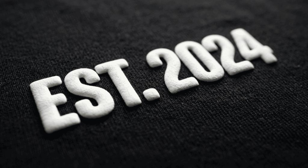 Detailed 3D puff printed typography on gray hoodie.
