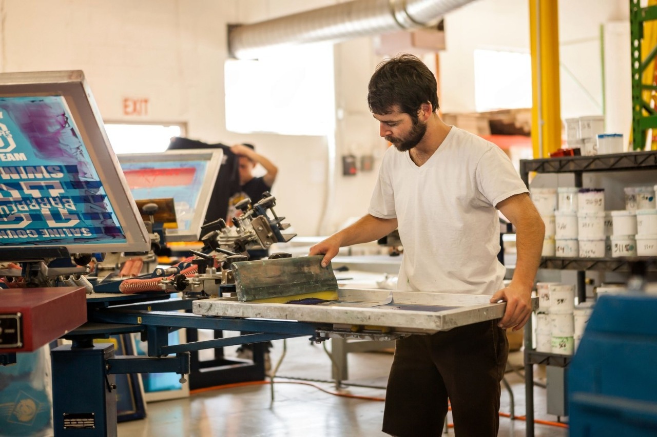 A man confidently modeling a freshly printed custom graphic tee, demonstrating the premium quality and sharp details delivered by expert Men's Affordable T-Shirt Printing Services for those seeking reliable affordable t-shirt printing and custom t shirts.